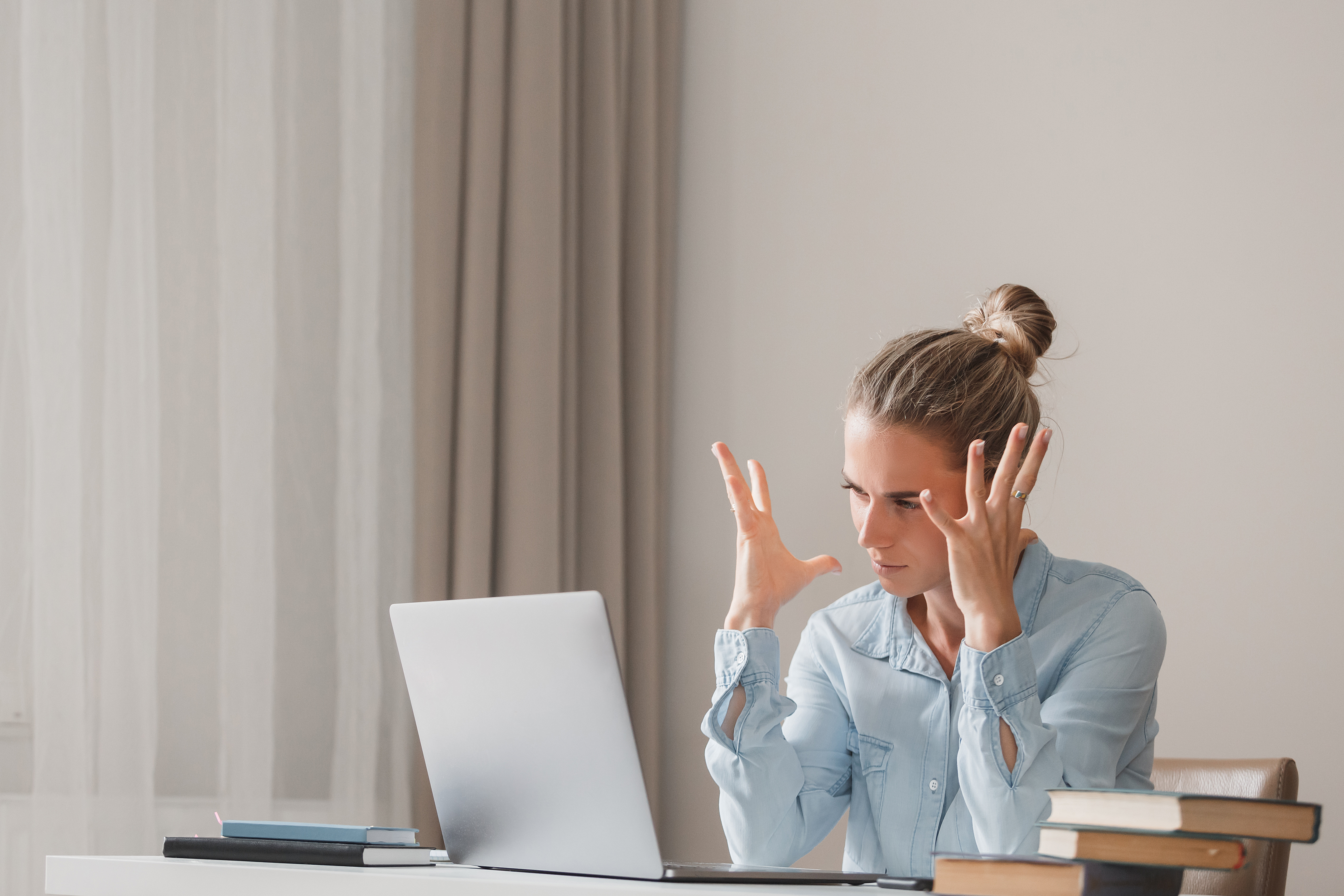 Upset young beautiful woman writer mad at slow work of software and computer. Charming young student was upset because of poor grades on test. Gadgets and Technology Concept. Difficulties and troubles