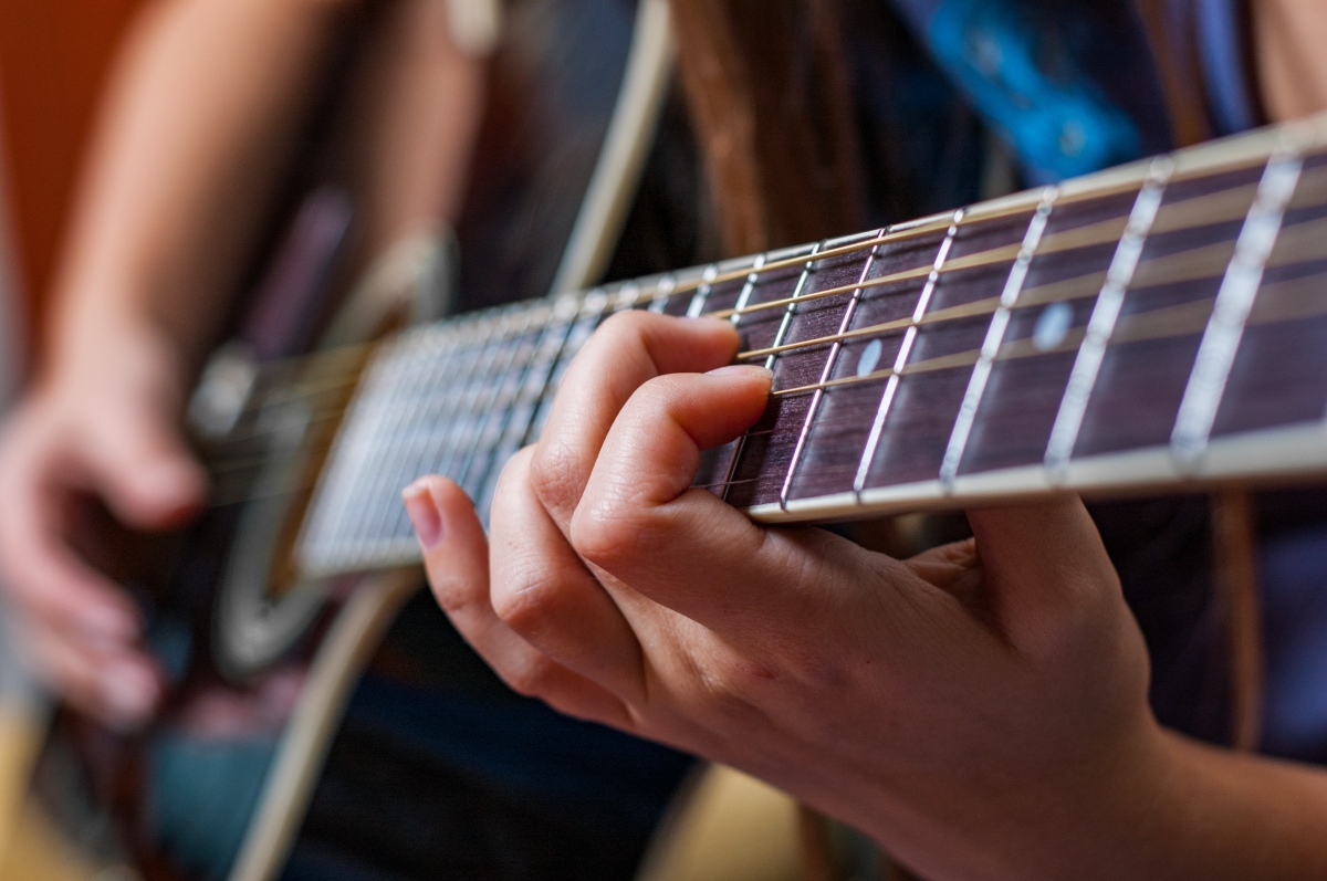Young Woman Playing Acoustic Guitar